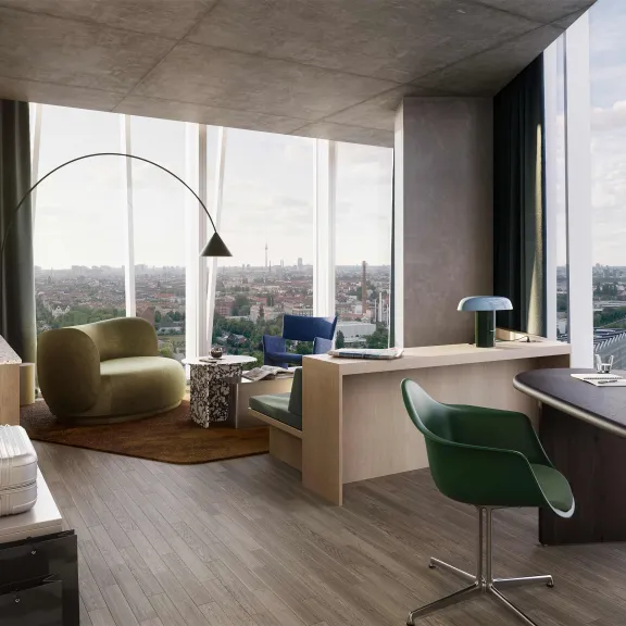 Modernes Büro mit großen Fenstern, Stadtblick, Schreibtisch und gemütlicher Sitzecke.
