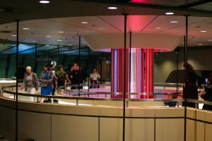 Besuchende stehen an einer Bar oder Lounge mit bunter Beleuchtung im ICC Berlin